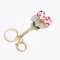 Detail of pink crystal cherry keychain with red rhinestones and golden lobster clasp - Green Leaf Bicolor