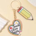 Detail view of teacher gift keychain with rainbow pencil and heart-shaped pendant charms - Heart Style