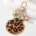 Golden keychain featuring a leopard print shell pendant and elegant faux pearl charms - Yellow Leopard