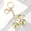 Glossy golden cherry resin keychain with metallic ring on a minimalist white background - Mirror Gold