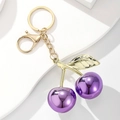 Exquisite purple cherry keychain with golden leaves and metallic mirror finish on white stand - Mirror Purple