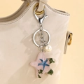 Portachiavi stella marina in resina rosa con glitter e perle su una borsa di pelle - Rosa
