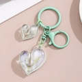Detail of transparent bubble heart charms with mint green clasp on pink background - Mint Green Dual Heart Style / Green