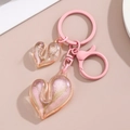 Detailed macro view of pink acrylic heart pendants with sparkly sand and bubble texture - Pink Dual Heart Style / Pink
