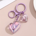 Detailed macro view of purple heart-shaped acrylic pendants with colorful laser effect finish - Purple Dual Heart Style / Purple