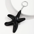 Detailed view of handmade black faux leather starfish keychain with silver metal ring - Black