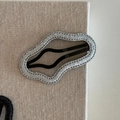 Macro shot of wavy glitter hair clip showing silver sparkle texture and fine stitching detail - Silver Cloud Wave (6#)