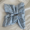 Detail of light blue embroidered flower scrunchie with white pearls on a soft background - Blue Floral Kite Scrunchie (With Pearl)
