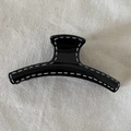 Black resin hair claw clip with white hand-drawn line accents on beige fabric background - Black Hanger Claw Clip