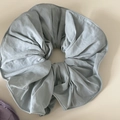 Close-up of grey-blue oversized scrunchie featuring high-quality pleated woven fabric - Light Blue