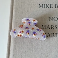 Floral acetate hair claw clip with colorful stars on a neutral linen book cover - Colorful Floral White Claw Clip