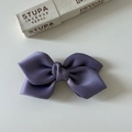 Detail view of a premium purple satin bow hair clip with layered silk ribbon texture - Purple