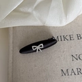 Macro shot of a black satin ribbon hair clip with a sparkling rhinestone bow detail - Chunky Arc Black Bow