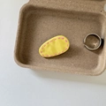 Close-up of a bright yellow oval hair clip with pink dotted patterns on a tray - Yellow Waterdrop Pink Stripe Clip