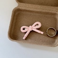 Detail of a pink polka dot bow hair clip and minimalist silver ring on white leather - Pink Bow White Polka Dot Thick Edge Clip