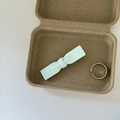 Detail of mint green polka dot bow hair clip and silver open ring in a natural pulp box - Single Blue Bow White Polka Dot Clip