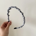 Detail of checkered fabric headband with non-slip inner teeth for secure hair styling - Black and White Plaid Style