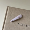 Detailed view of white fabric hair clip with red polka dots on a linen book background - 5# White Red Polka Dot Long Water Drop Clip