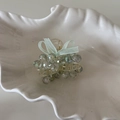 Close-up of a blue crystal beaded hair claw clip with a green chiffon bow on a white tray - Green Crystal Small Claw Clip