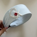 Close-up of a blue lace headband with white heart patch and red button detail - 3# Solid Blue Headband Heart