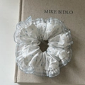 Elegant white scrunchie with light blue polka dots and delicate lace trim for hair styling - White With Blue Polka Dots