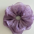 Macro view of lilac pleated mesh hair scrunchie with detailed ruffled edges and fine stitching - Purple