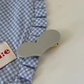Close-up of a matte grey heart-shaped acrylic hair clip with a golden metal duckbill clip - Gray Heart Hair Clip