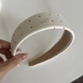 Close-up of cream polka dot headband featuring a delicate embroidered bow design - Cream Polka Dot Embroidery Headband