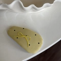 Close-up of yellow polka dot fabric hair clip with delicate green bow embroidery detail - Turmeric Polka Dot Waterdrop Hair Clip