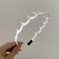 Detail of white striped fabric headband featuring translucent spike decorative elements - Teeth Headband (5855935401485) / White (1# White Wrapped Headband With Teeth)