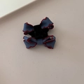 Detail of a dark blue fabric bow hair clip with decorative red scalloped edge stitching - Dark Blue Denim Bow Hair Claw