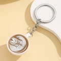 Detailed macro shot of miniature coffee cup keychain with leaf pattern latte art design - Khaki (Without Light)