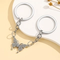 Macro shot of sparkling rhinestone butterfly pendant on double silver keyrings - Rhinestone Butterfly