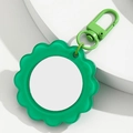 Détail du porte-clés miroir de poche tournesol avec pétales verts et fermoir homard - Vert