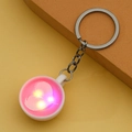 Detail shot of a creative white coffee cup keychain glowing with bright pink LED light - Pink (With Light)