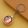 Detail showing glowing LED coffee cup keychain with latte art design and metal ring - Khaki (With Light)