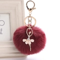 Close-up of wine red faux fur pompom keychain with golden ballerina rhinestone pendant - 8cm Faux Rex Rabbit Fur / Burgundy