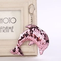 Sparkly pink sequin dolphin keychain with silver ring hanging on a vintage photo frame - 14cm x 8cm / Pink