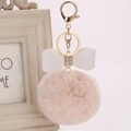 Pink rabbit fur pompom keychain with white leather bow and sparkling rhinestone details - 8cm / Off-white