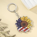 US-Flaggen-Sonnenblumen-Schlüsselanhänger mit Silberring auf beigem Hintergrund - Amerikanische Flagge Sonnenblume