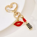 Golden heart keychain featuring red enamel lips and a black rhinestone lipstick pendant - Red Lips Lipstick Heart Charm (如图款钥匙扣)