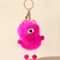 Detailed view of fluffy rose pink plush monster keychain with gold metallic ring clasp - Rose Red