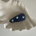 Detail of blue denim BB hair clip featuring three light blue heart beads on a white tray - Dark Denim Blue Heart