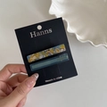 Detail van twee acetaat haarklemmen in bloemenprint en blauw op een displaykaart - 3# Blauw Geel Marmer