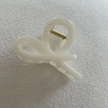 Detail view of the cream white matte hair claw clip featuring a golden metal spring - 16#
