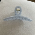 Macro shot of light blue jelly finish hair claw clip with golden metal spring detail - Light Blue Cross Twist (18#)