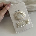 Detail of cream lace hair clips with satin bow and pearl on textured fabric card - 2# White Oval Wave Duckbill Clip