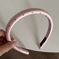 Close-up of pink padded satin headband with black polka dots and inner brand label - 2CM Padded / Pink Polka Dot Headband