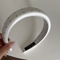 Detailed view of the thick black and white polka dot satin headband with inner woven label - 3CM Padded / White Polka Dot Headband