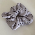 Detailed view of a lavender scrunchie featuring black heart polka dots and ruffled fabric texture - Purple Scrunchie (Heart)